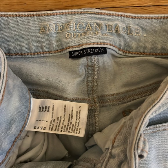 size 2 super stretch light wash blue jeans with rips - Picture 2 of 2